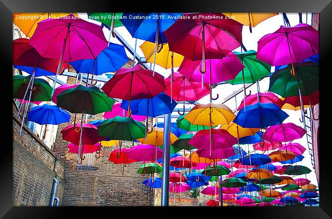 Umbrellas in Vinopolis Piazza Framed Print by Graham Custance