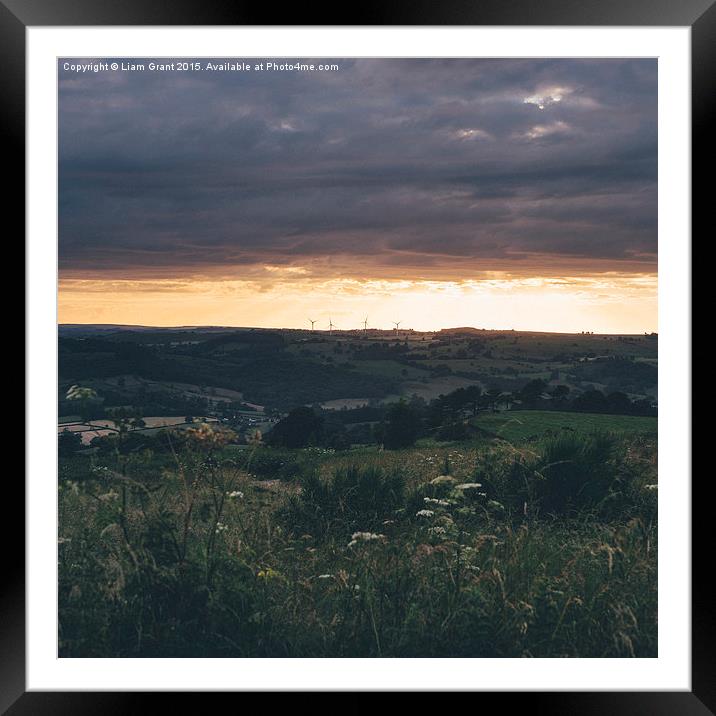 Distant windfarm at sunset.  Framed Mounted Print by Liam Grant