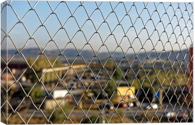 Wire fence to protect the industrial landscape Canvas Print by Adrian Bud