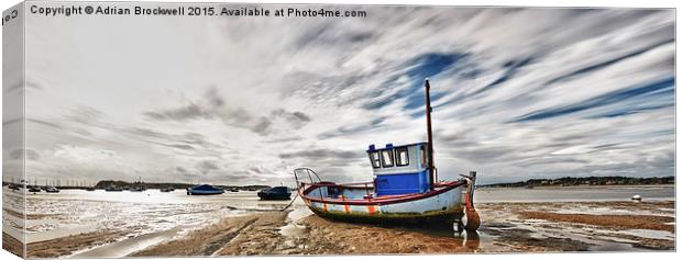 Fishing Boat at low tide Canvas Print by Adrian Brockwell