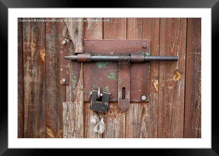 sliding bolt unlocked and padlock Framed Mounted Print by Arletta Cwalina