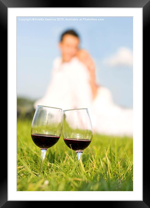 two wineglasses with red wine in grass  Framed Mounted Print by Arletta Cwalina