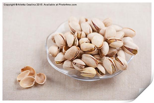 pistachio nuts in shell lying on glass plate  Print by Arletta Cwalina