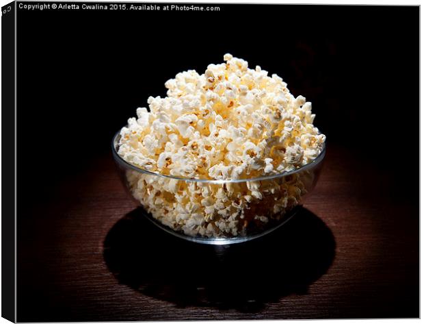popcorn in glass bowl and black shadow around  Canvas Print by Arletta Cwalina