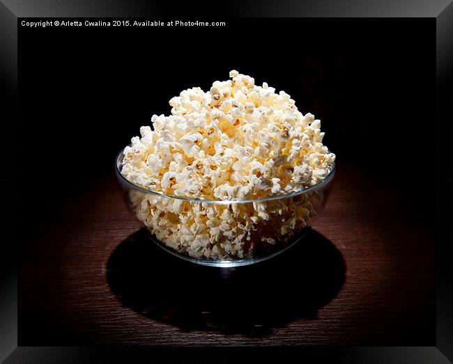 popcorn in glass bowl and black shadow around  Framed Print by Arletta Cwalina