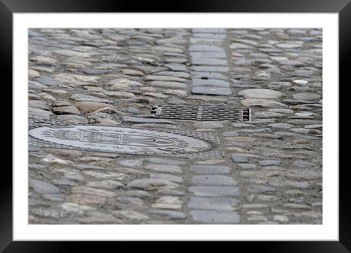 Paving of river rock and manhole covers cast iron Framed Mounted Print by Adrian Bud