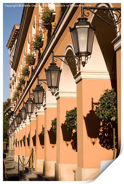 Row of lamps on columns of building  Print by Arletta Cwalina