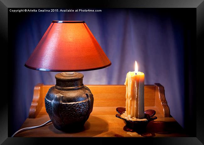 electrical night light lamp and burning candle  Framed Print by Arletta Cwalina