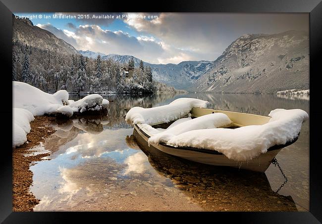 Snow covered boat on Lake Bohinj in Winter Framed Print by Ian Middleton