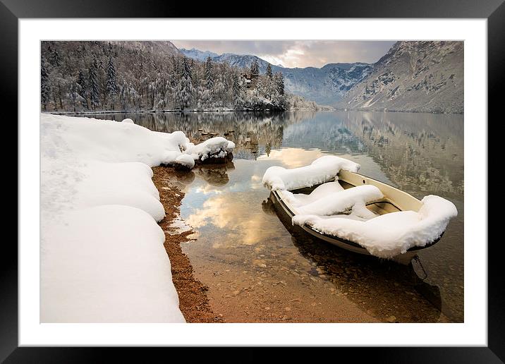 Snow covered boat on Lake Bohinj in Winter Framed Mounted Print by Ian Middleton