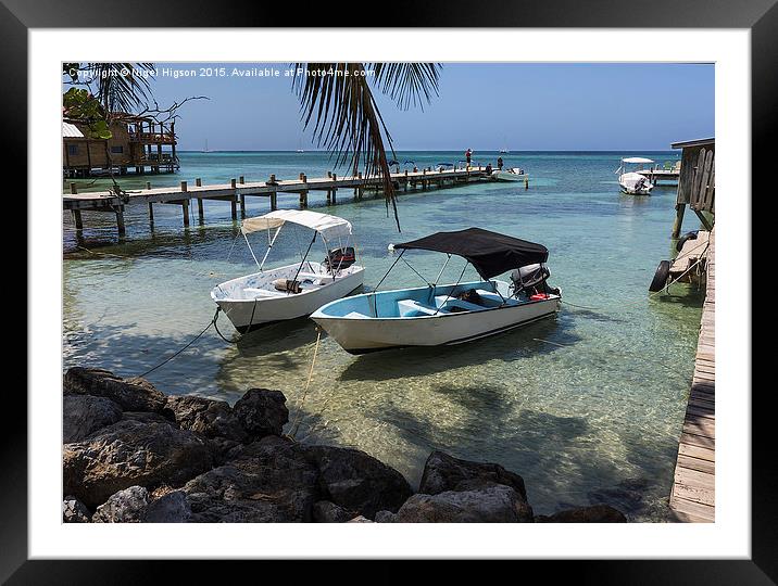  Boats rest in the clear waters of Roatan Framed Mounted Print by Nigel Higson