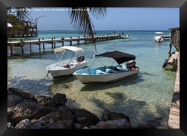  Boats rest in the clear waters of Roatan Framed Print by Nigel Higson