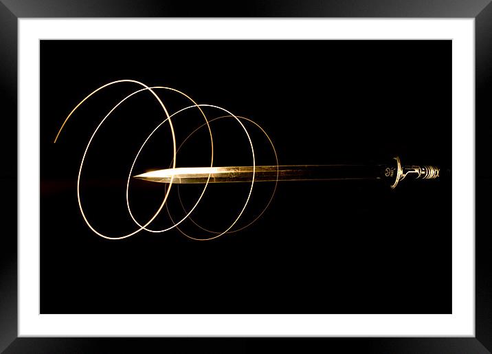 Light trails around a sword Framed Mounted Print by Eddie Howland