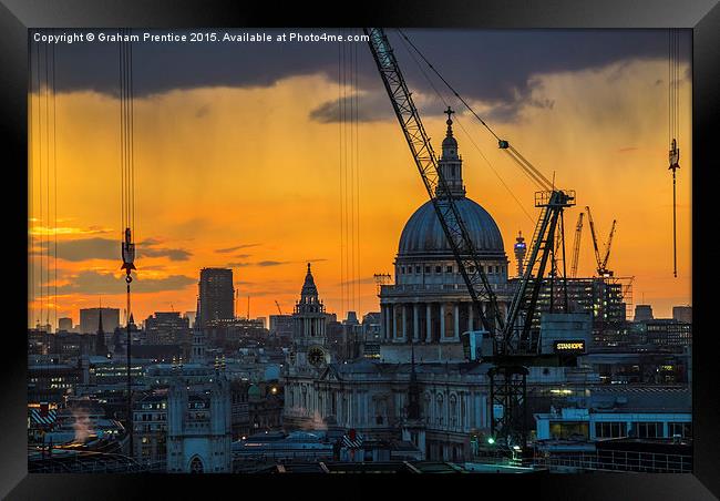 Sunset over St Paul's Cathedral with cranes Framed Print by Graham Prentice