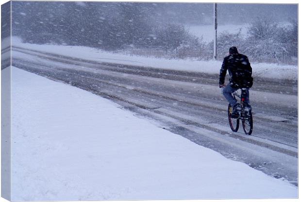 Cyclist In The Snow Canvas Print by val butcher