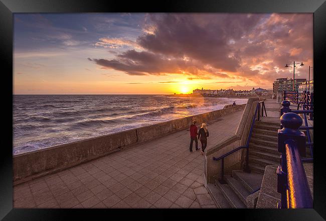   Couple enjoying the Porthcawl sunset Framed Print by Dean Merry