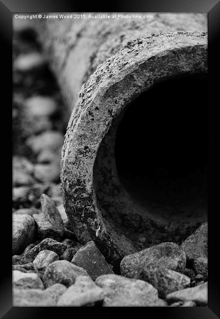 Pipe and pebbles Framed Print by James Wood