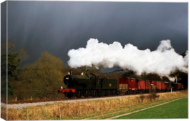 Goods train running ahead of a snowstorm  Canvas Print by Ian Duffield