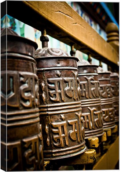 Tibetan Buddhist prayer wheels of Boudhanath stupa Canvas Print by Julian Bound