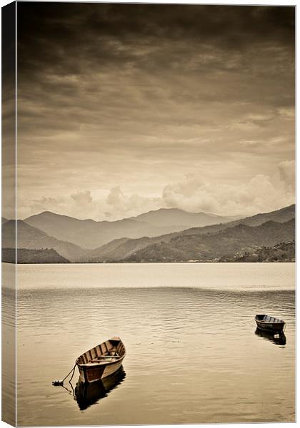  Lone boats on Fewa Lake, Pokhara, Nepal Canvas Print by Julian Bound