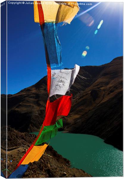 The Yamdrok Lake of Tibet with prayer flags Canvas Print by Julian Bound