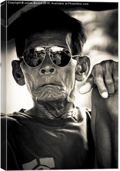 Man in sunglasses in Yogyakarta, Indonesia Canvas Print by Julian Bound