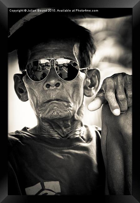 Man in sunglasses in Yogyakarta, Indonesia Framed Print by Julian Bound