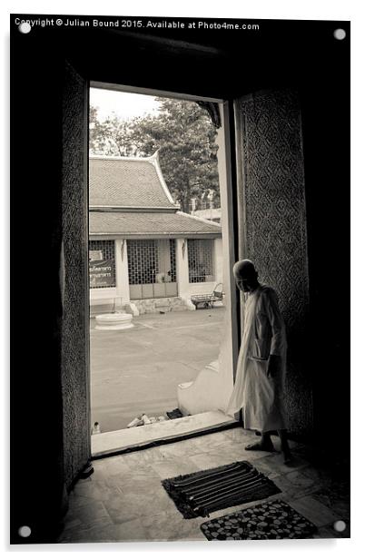 A nun in a doorway of a temple in Bangkok, Thailan Acrylic by Julian Bound