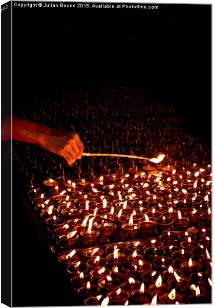  Candle blessings, Kathmandu, Nepal Canvas Print by Julian Bound