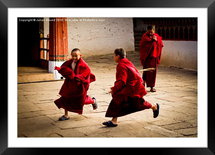  Monks at play in Rinpung Dzong Fort, Bhutan Framed Mounted Print by Julian Bound