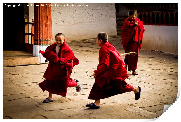  Monks at play in Rinpung Dzong Fort, Bhutan Print by Julian Bound