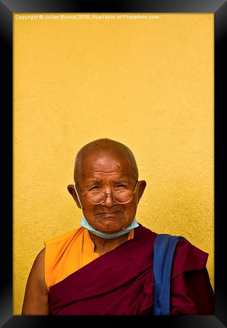 Elderly Tibetan Buddhist monk, Boudhanath, Kathman Framed Print by Julian Bound
