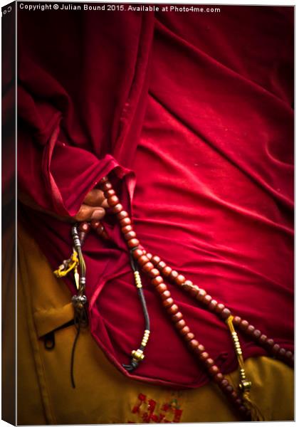 Tibetan monk and beads, Boudhanath Temple, Kathman Canvas Print by Julian Bound