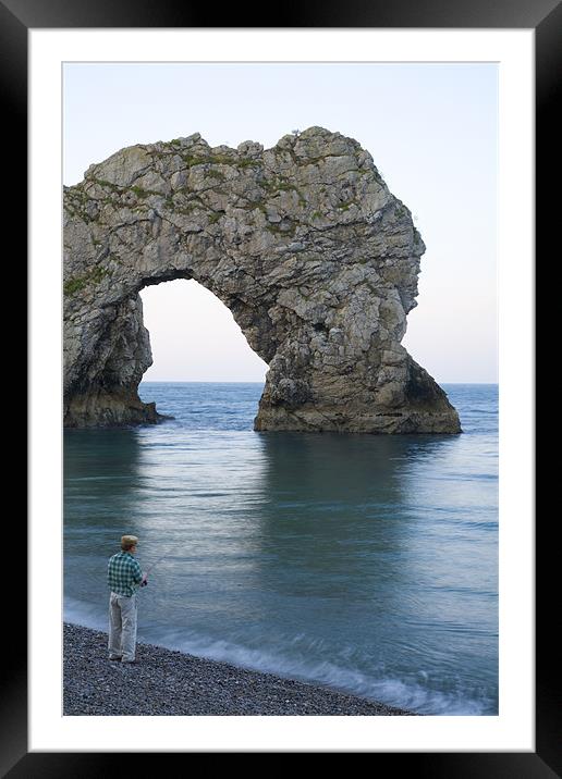 Man fishing at Durdle Door near Lulworth cove. Framed Mounted Print by Ian Middleton