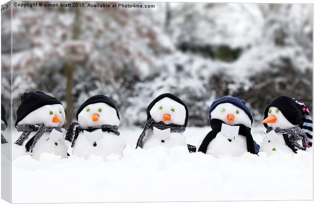 Cute snowman group in snow  Canvas Print by Simon Bratt LRPS