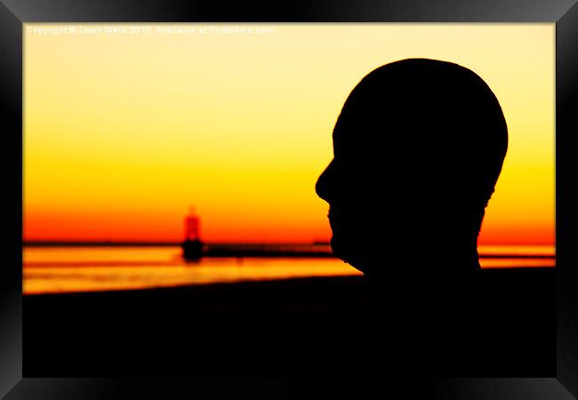 Silhouette of an Iron Man at sunset  Framed Print by Jason Wells