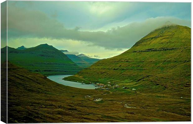  Mountains and small village in the Faroe Islands Canvas Print by Sue Bottomley
