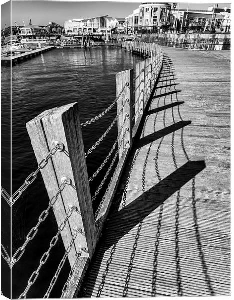  Cardiff Bay shadows on the boardwalk Canvas Print by Andrew Richards