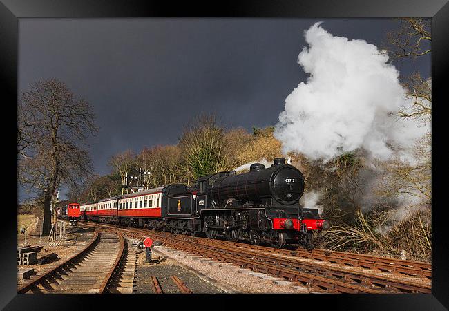 Steam train arriving under threatening skies Framed Print by Ian Duffield
