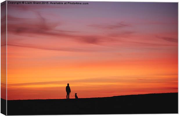 Female walking her dog, silhouetted at sunset. Wal Canvas Print by Liam Grant