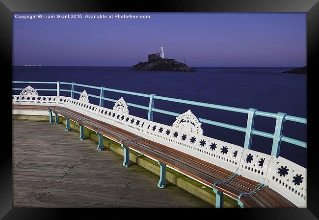 Lighthouse at dusk from Mumbles Pier. Wales, UK. Framed Print by Liam Grant