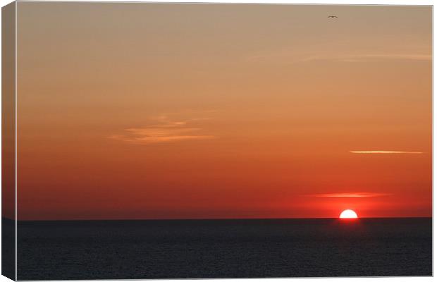  Cornish sunset with the sun setting into the atla Canvas Print by Chris Warham
