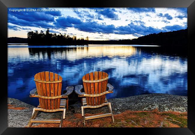 Wooden chairs at sunset on lake shore Framed Print by ELENA ELISSEEVA
