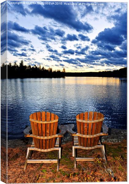 Wooden chairs at sunset on lake shore Canvas Print by ELENA ELISSEEVA