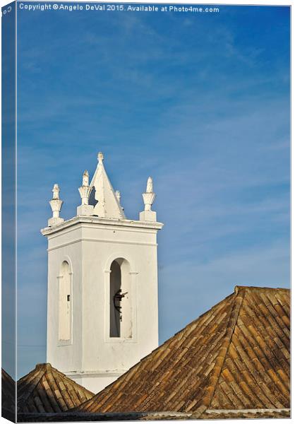 Church bell tower behind tiled roofs in Tavira  Canvas Print by Angelo DeVal