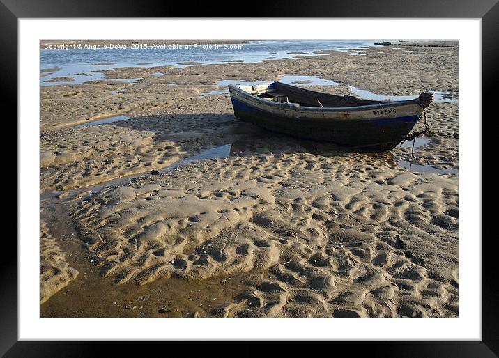Fishing boat resting on the beach sand  Framed Mounted Print by Angelo DeVal