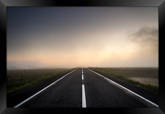  Road over the misty moors at sunset Framed Print by Andrew Kearton