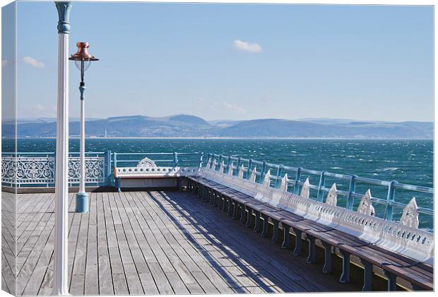 Lamp and seating on Mumbles Pier. Wales, UK. Canvas Print by Liam Grant