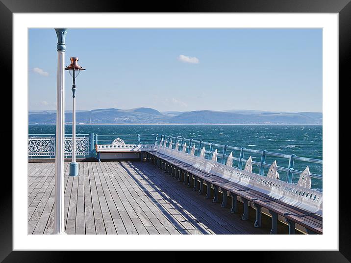 Lamp and seating on Mumbles Pier. Wales, UK. Framed Mounted Print by Liam Grant