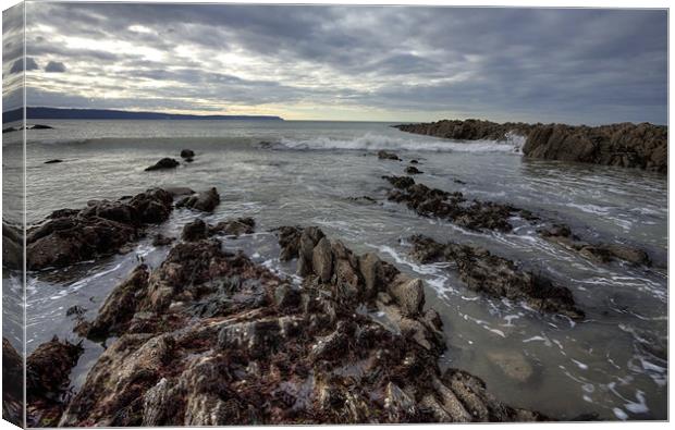 Rocks and Wave Canvas Print by Mike Gorton